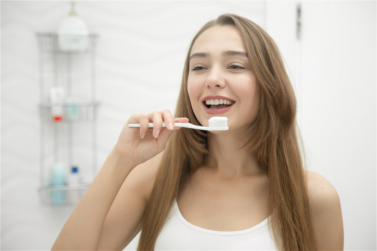 portrait-of-a-young-smiling-girl-cleaning-her-teeth.jpg