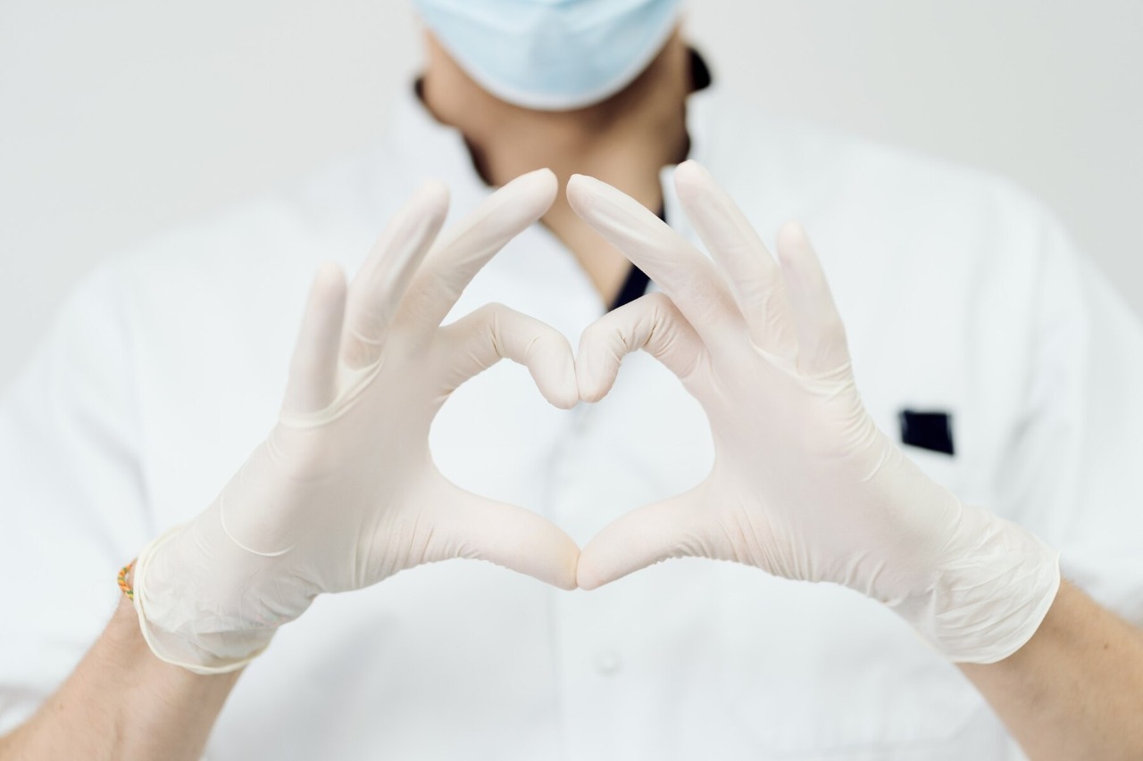 attractive-male-doctor-show-heart-sign-with-hands-isolated-on-white-wall_158595-7680.jpg